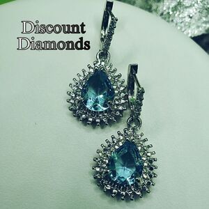Tear drop blue topaz drop earrings surrounded by Baguette diamonds on 925 silver